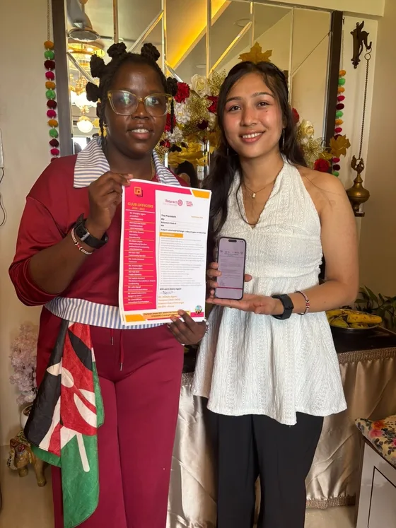 Club presidents displaying exchanged official letterheads during the India visit