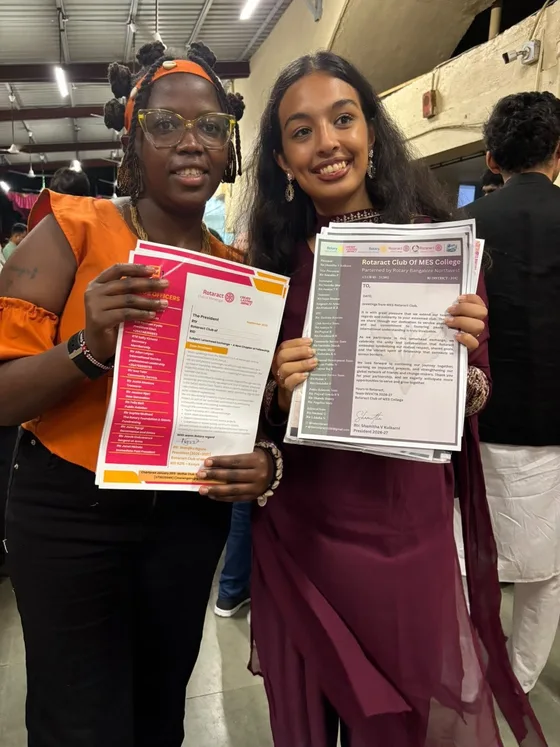 Club presidents displaying exchanged official letterheads during the India visit