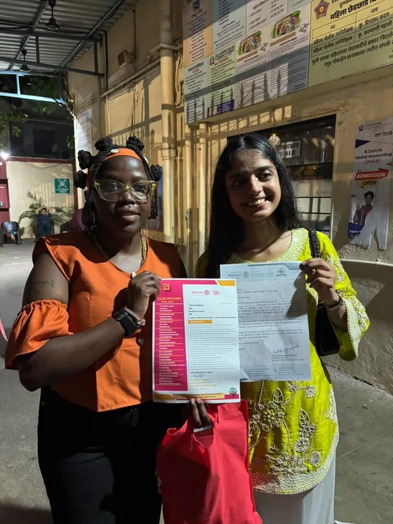 Club presidents displaying exchanged official letterheads during the India visit