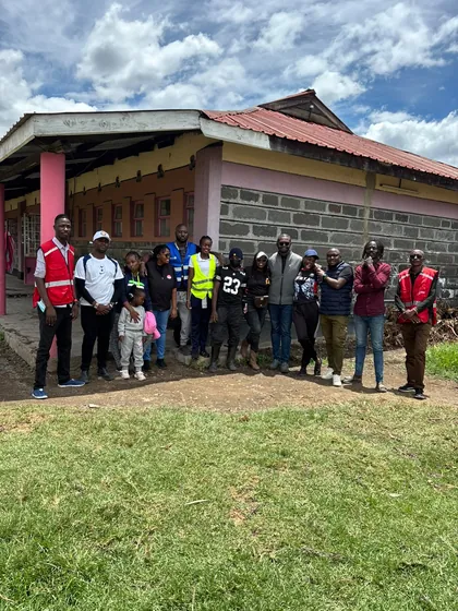 The group gathered outside the school buildings