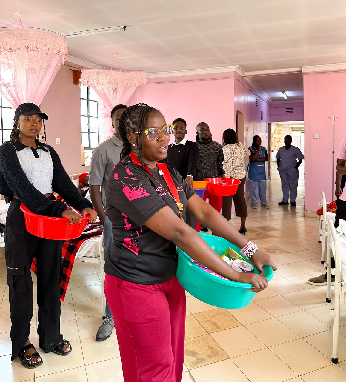 A member carries mother packs through the maternity ward at Bondeni