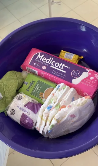 A mother pack: pads, wipes and supplies in a basin