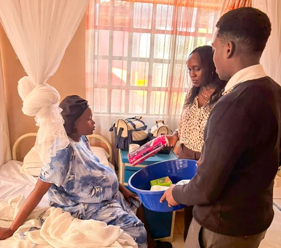 Supplies handed to a mother at Bondeni Maternity