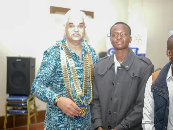 A member welcomed alongside Rotary leadership at the ceremony