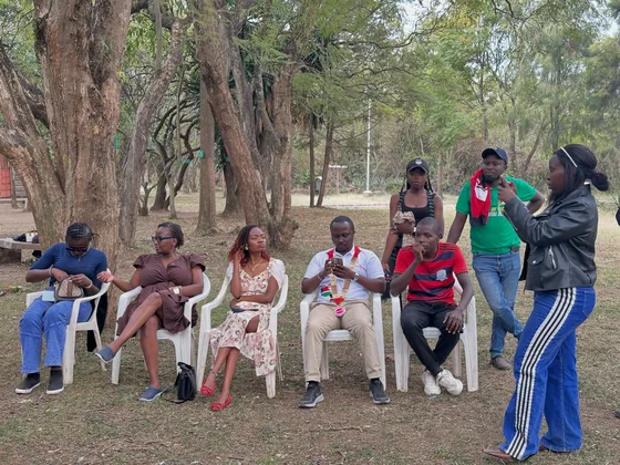 Participants sharing conversation outdoors at Hyrax Hill