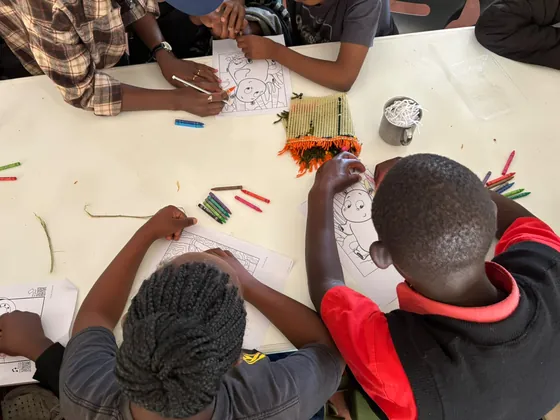 Crayons and paper at work during the art session