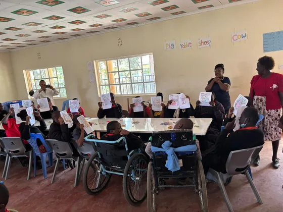 Learners hold up their drawings at Pangani Special School
