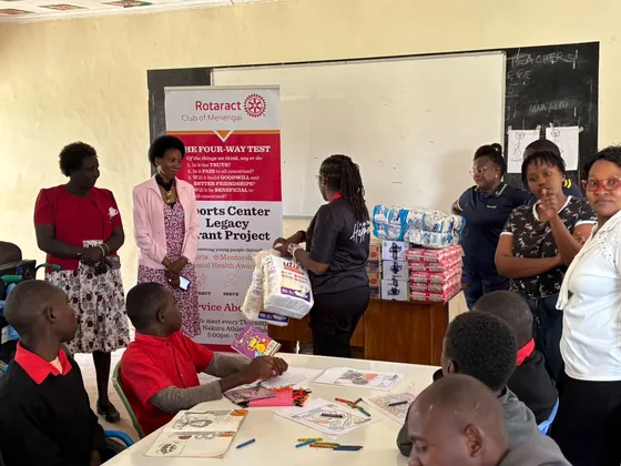 Members with the club banner at Pangani Special School