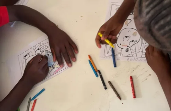 Learners drawing and colouring during the art session