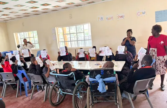 Learners and volunteers gathered around tables during Empowering Minds