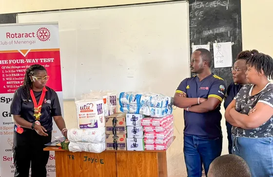 Club volunteers beside donated essential supplies at Pangani Special School