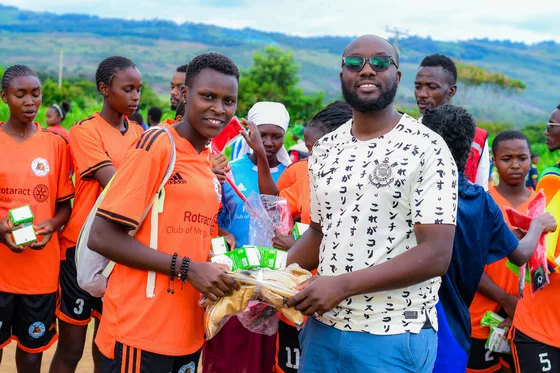 A participant receiving sports equipment during the project