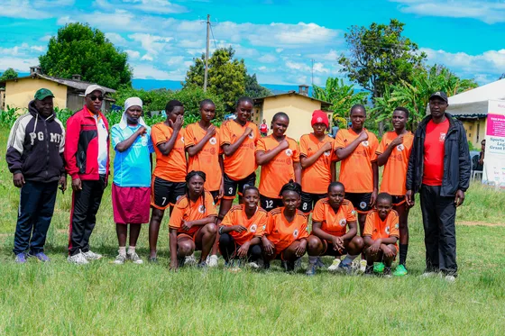 A team in orange kits gathered for a group photograph